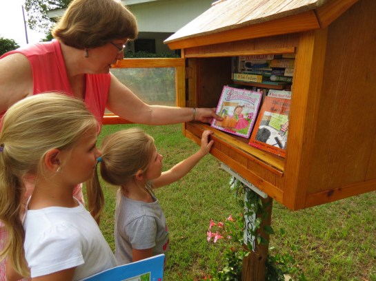 Founder Lisbeth Kidd welcomes young patrons to Esto's Little Free Library.